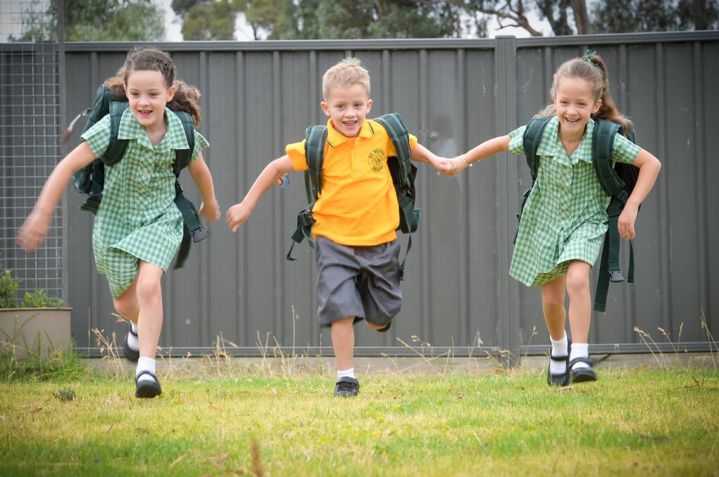 Ready, set, go: the Higgins triplets are off to school. Picture: DARREN HOWE