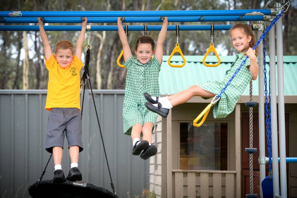 The Higgins triplets are ready for school. Picture: DARREN HOWE