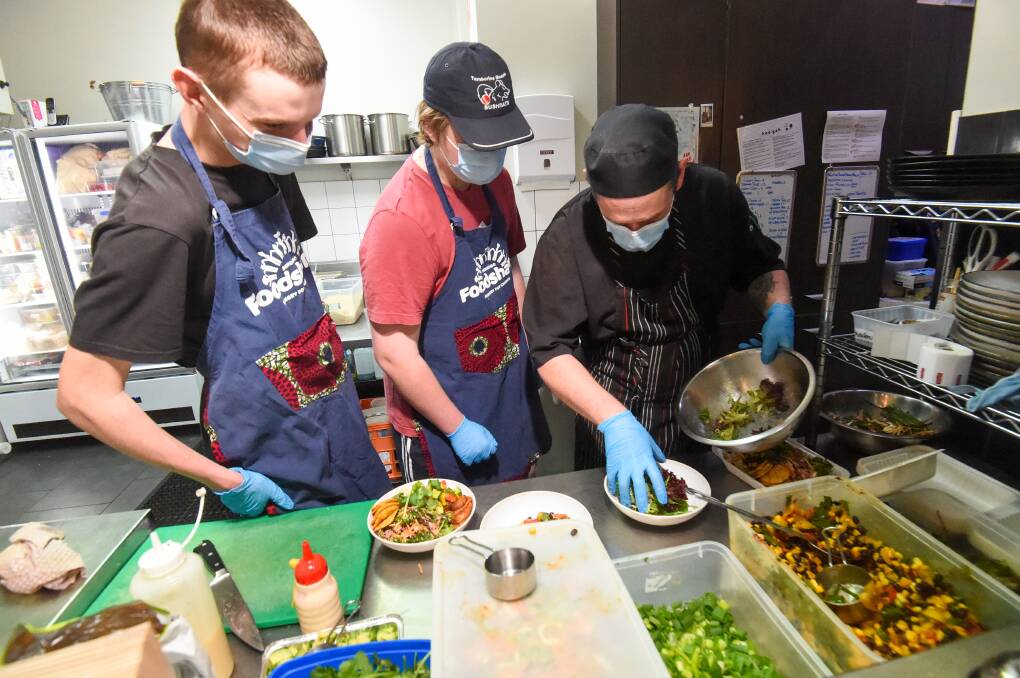 Making lunch: Thomas Reid and Sam Hollingsworth with chef Lee Bryant at the Hoo-Gah cafe. Picture: DARREN HOWE 