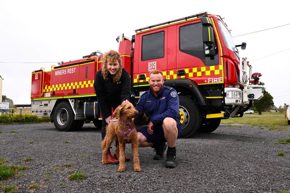 RSPCA Victoria's Head of Prevention Rebecca Cook and Miners Rest Fire Brigade's Garth Trengove with Minnie the dog. Picture by Adam Trafford