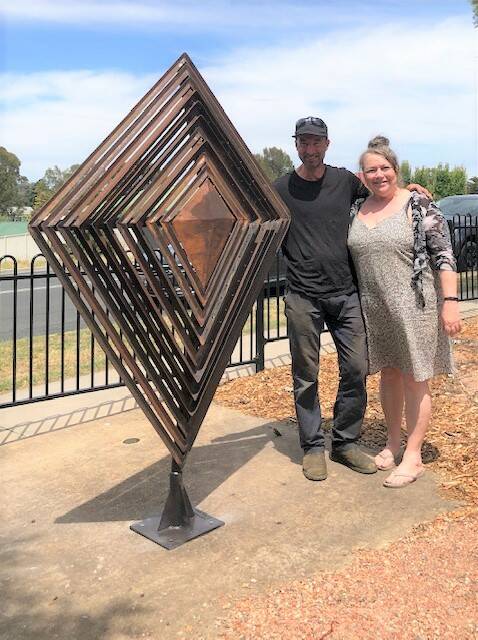 Artists Andre Sardone and Lorraine Brigdale with the shield sculpture. Picture: JUDITH CHALMERS