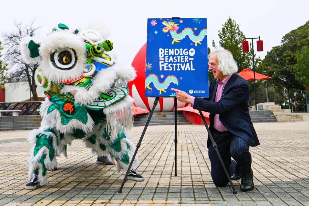 Greater Bendigo councillor Rod Fyffe shows a Chinese lion new logos and branding for the Easter festival, as planning begins for the 2023 version. Picture: DARREN HOWE.