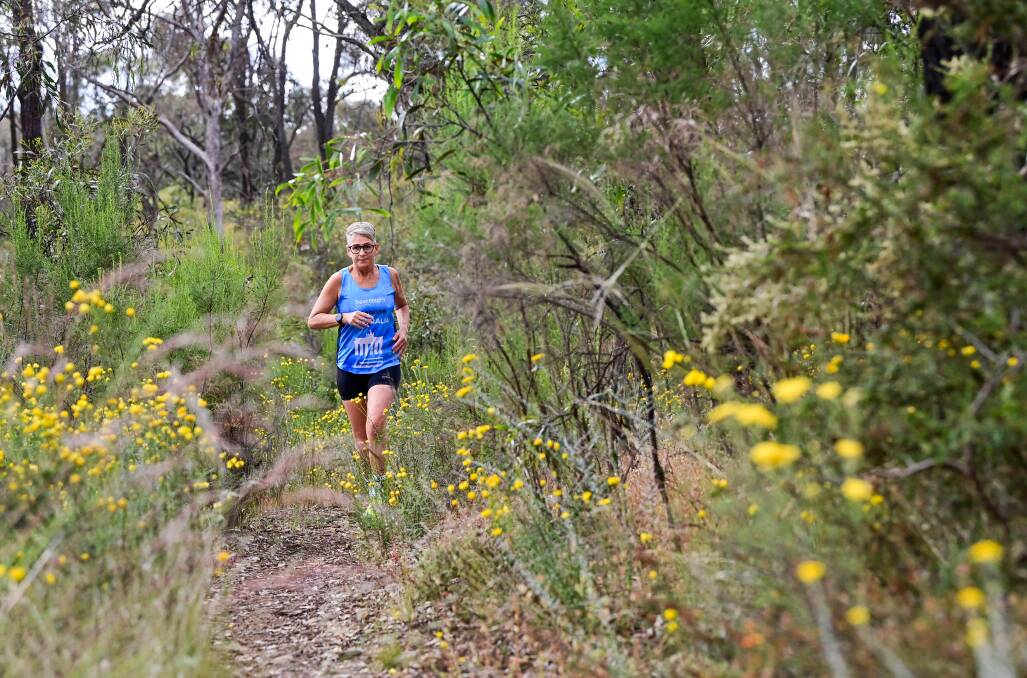 Frances Walsh running through the bush in Long Gully. Picture by Brendan McCarthy