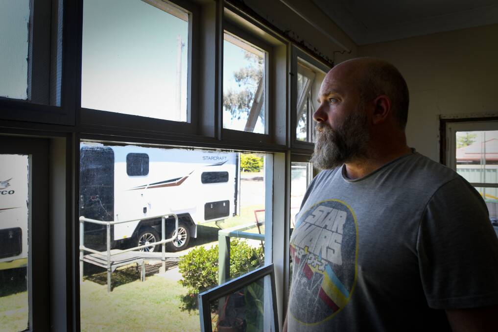Leigh Wilson looking out at his mother's new caravan. Picture by Noni Hyett