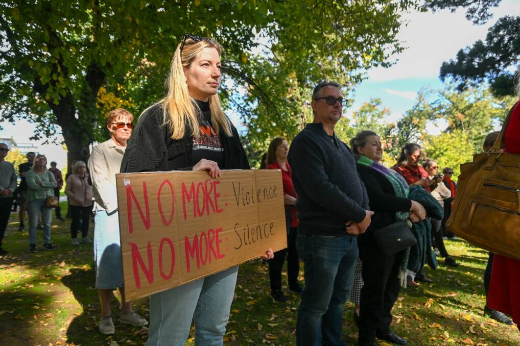 A woman holds a banner at last Sunday's 'No More' violence rally in Rosalind Park. Picture by Enzo Tomasiello