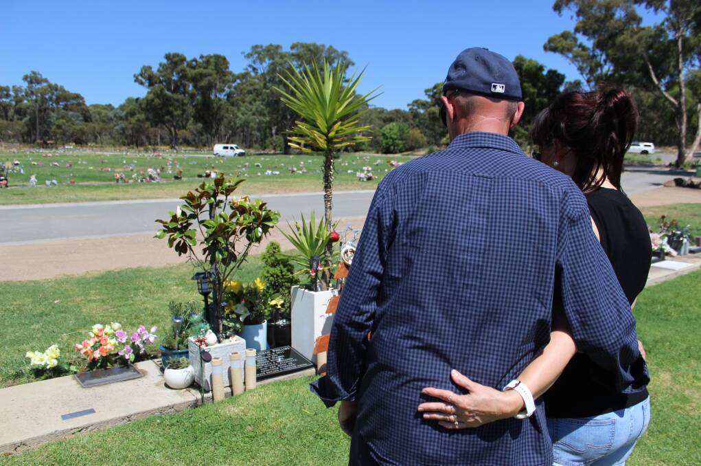 Doug and Dianne Phillips survey the memorial they have created for their son, Blake, which they tend every day. 