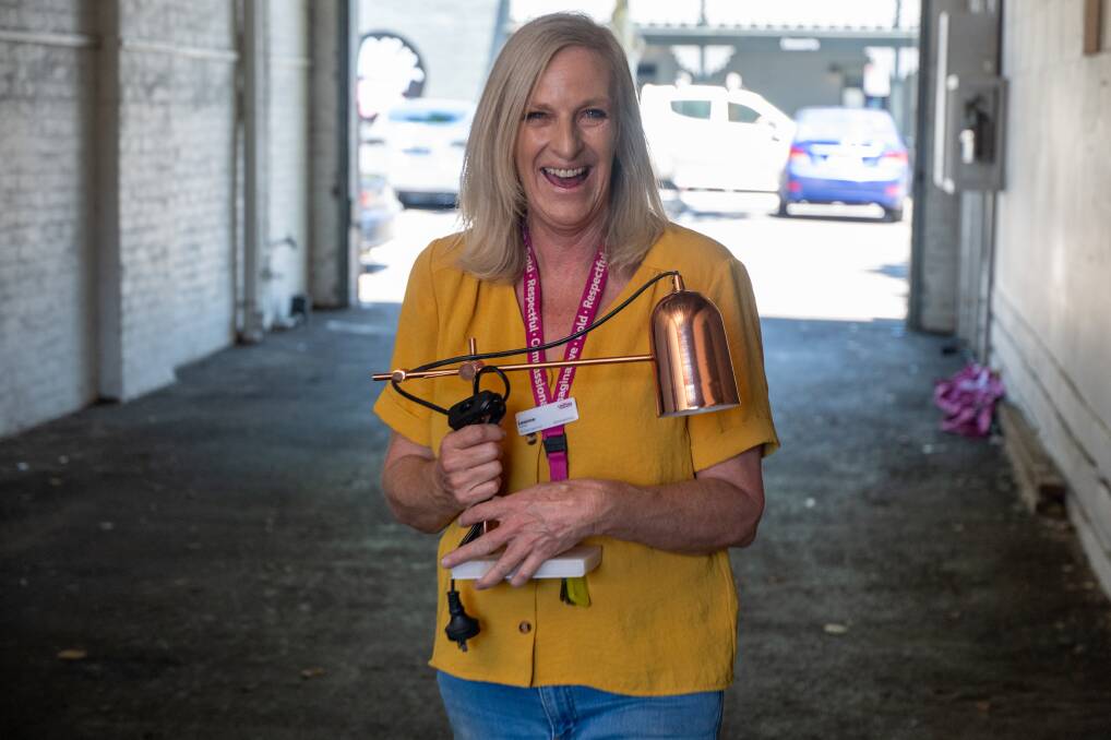 Uniting Bendigo manager Leanne Tingley handles a donated lamp. Picture by Enzo Tomasiello