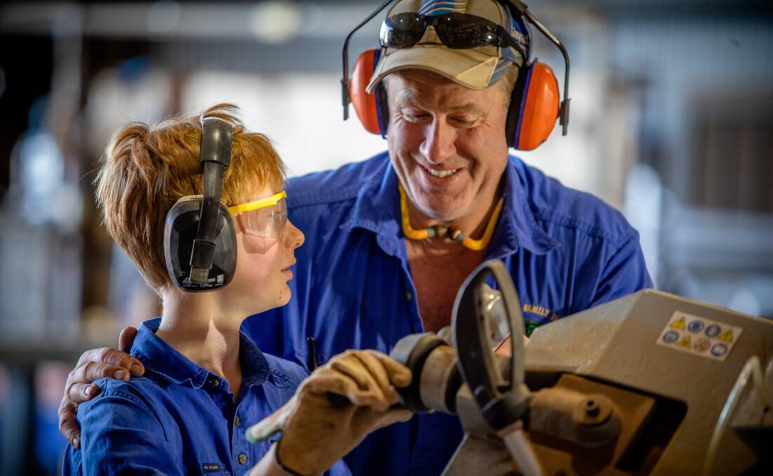 Parents should always supervise children when working on the farm. Pictured is Peter Thompson and son Luke in the workshop on their farm at Manangatang. Photo: Supplied.