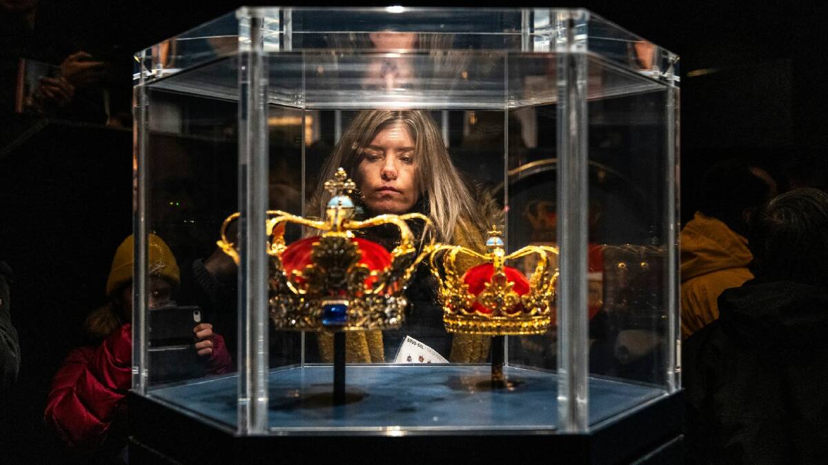 A person looks at Christian V's crown and the Queen's crown, made for Christian VI's Queen Sophie Magdalene, on display at Rosenborg Castle in Copenhagen, Denmark. (EPA/Ida Marie Odgaard)