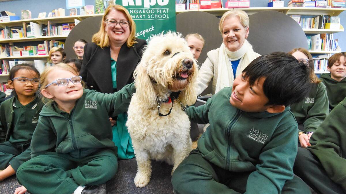  WELLBEING DOG: Education Minister Natalie Hutchins visits Kangaroo Flat Primary School to announce mental health funding for schools, pictured here with Member for Bendigo West Maree Edwards, the school's students and, of course, Bonnie the wellbeing dog. Picture: DARREN HOWE 