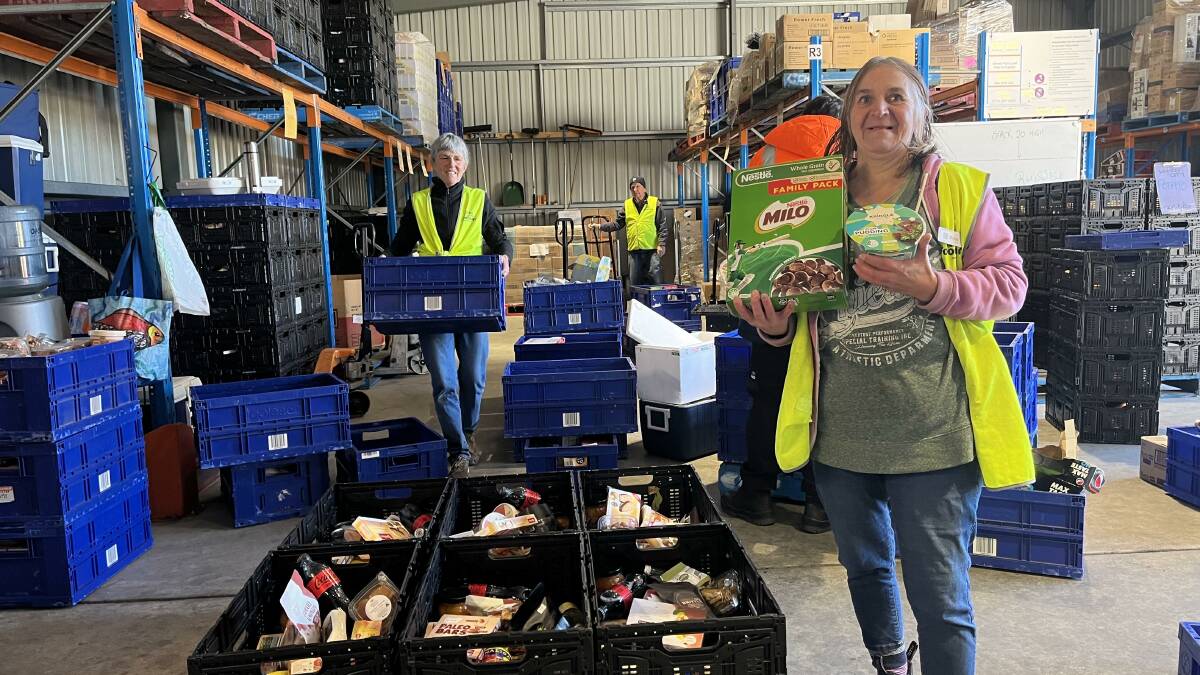 HELPING HANDS: Bendigo Foodshare volunteers sort through thousands of donated food items collected during Bendigo's June Food Drive. Picture: supplied 