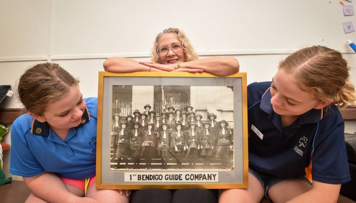 Bendigo Girl Guides Ruby Haley and Hannah Evans, with group leader Julie Kala, are celebrating 100 years. Picture by Darren Howe