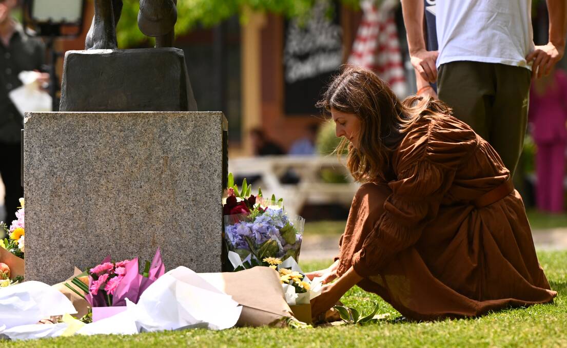 As Monday dawned in Daylesford, hundreds of flowers appeared at a statue close to the site of the crash, which has claimed five lives from two Wyndham area families.. Picture by Adam Trafford.