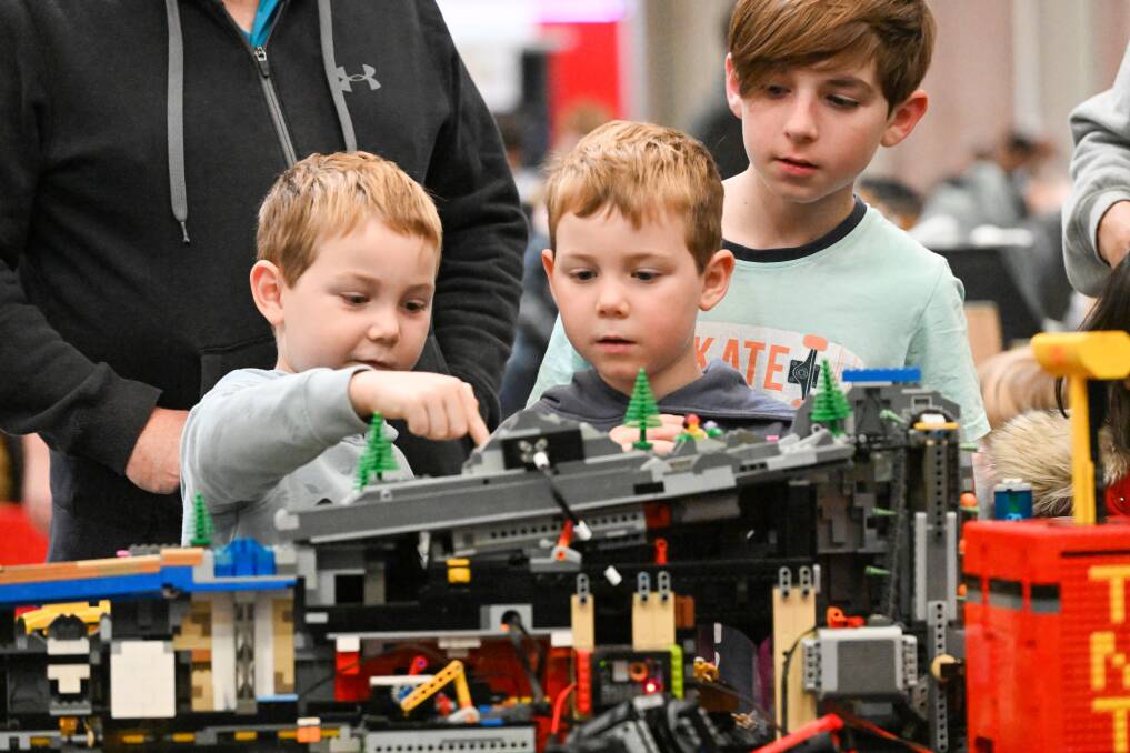 Oliver, William, and James Dawborn check out a display at Bendigo Bricks 2023. Picture by Darren Howe
