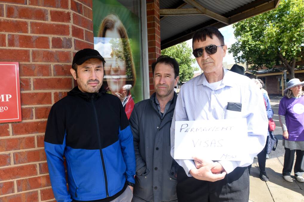 Temporay visa holders Hussain Sultani (left) and Mohammad Zaman (right) with Australian citizen Sayed Balkhi at a protest for the government to make temporary visa holders permanent residents. Picture by Noni Hyett
