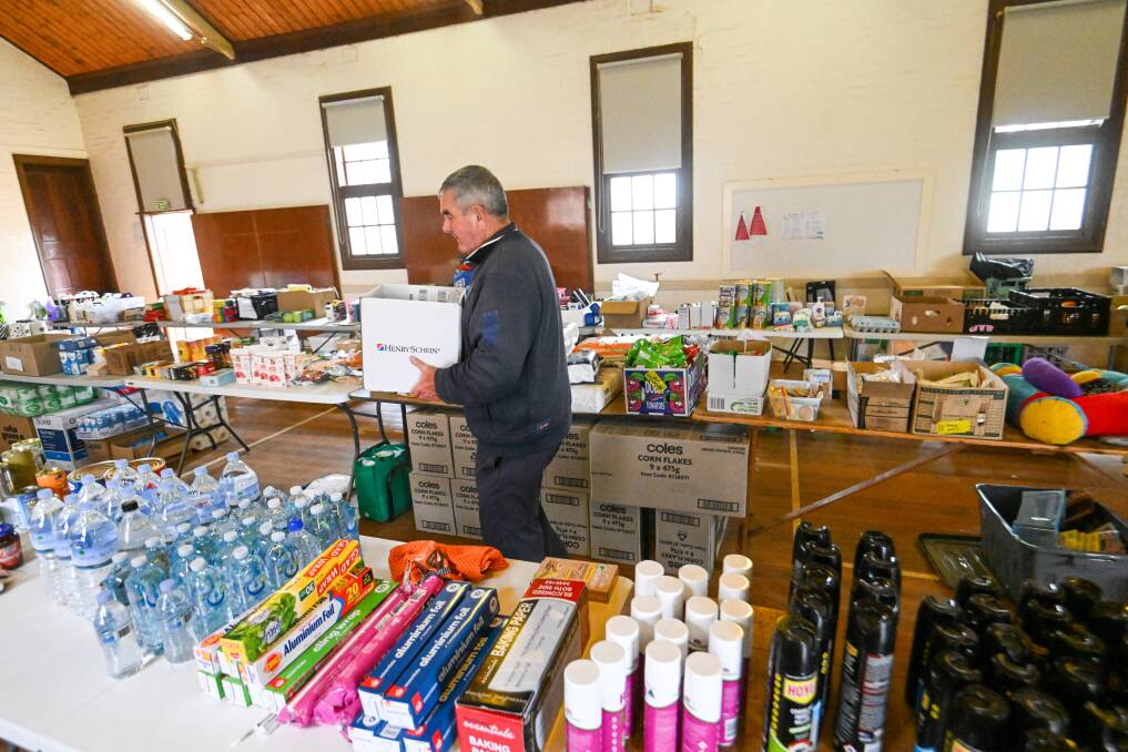 Volunteer Russell Chapman sorts food at Rochester's food share site.