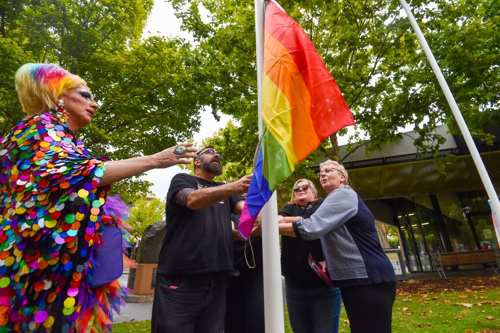 Bendigo Pride Festival representatives, sponsors and City of Greater Bendigo mayor Cr Andrea Metcalf raise the Pride flag. Picture by Darren Howe 