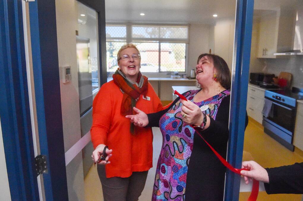 City of Greater Bendigo mayor Andrea Metcalf and Long Gully Neighbourhood Centre coordinator Kerry Parry cut the ribbon of the centre's new kitchen. Picture by Darren Howe 
