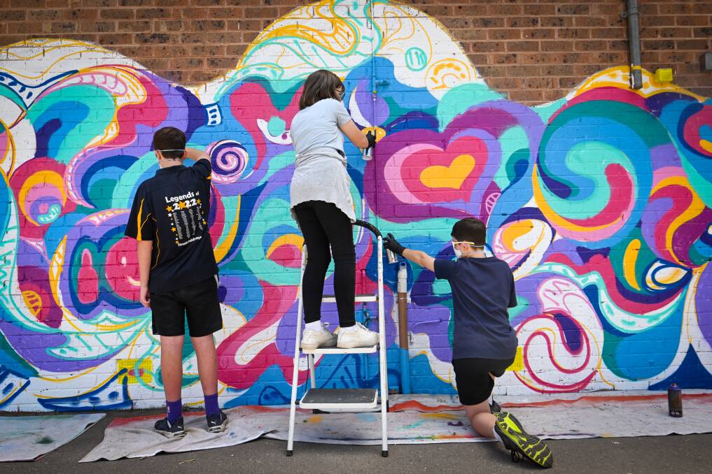 Zach Arthur-West, Frankie Buzza and Keelan McInerney work on Strathfeildsaye Primary School's new mural. Picture by Darren Howe
