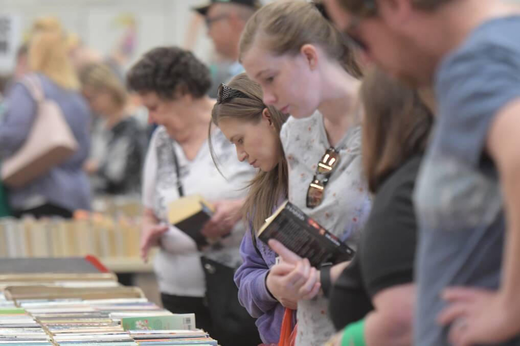 Keen book lovers peruse the selection at the 2019 Easter Book Fair. Picture by Noni Hyett