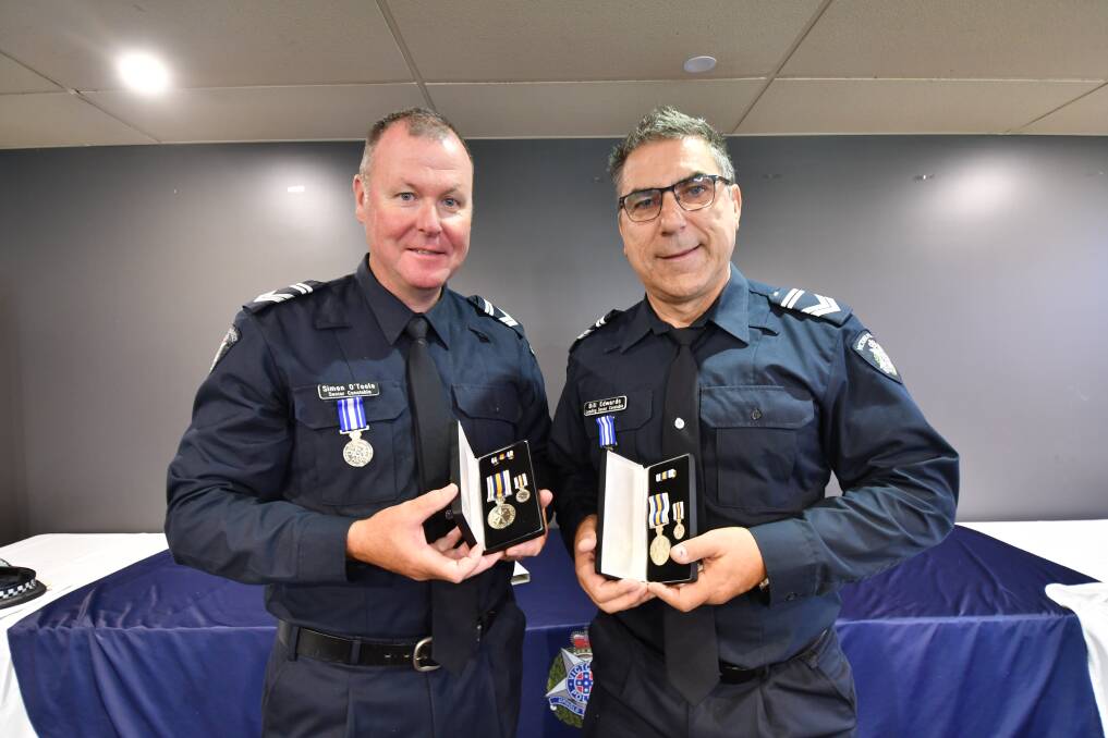 Senior constable Simon O'Toole and leading senior constable Bill Edwards were awarded National Police Service Medals for providing a minimum of 15 or more years diligent and ethical service to policing. Picture by Jonathon Magrath