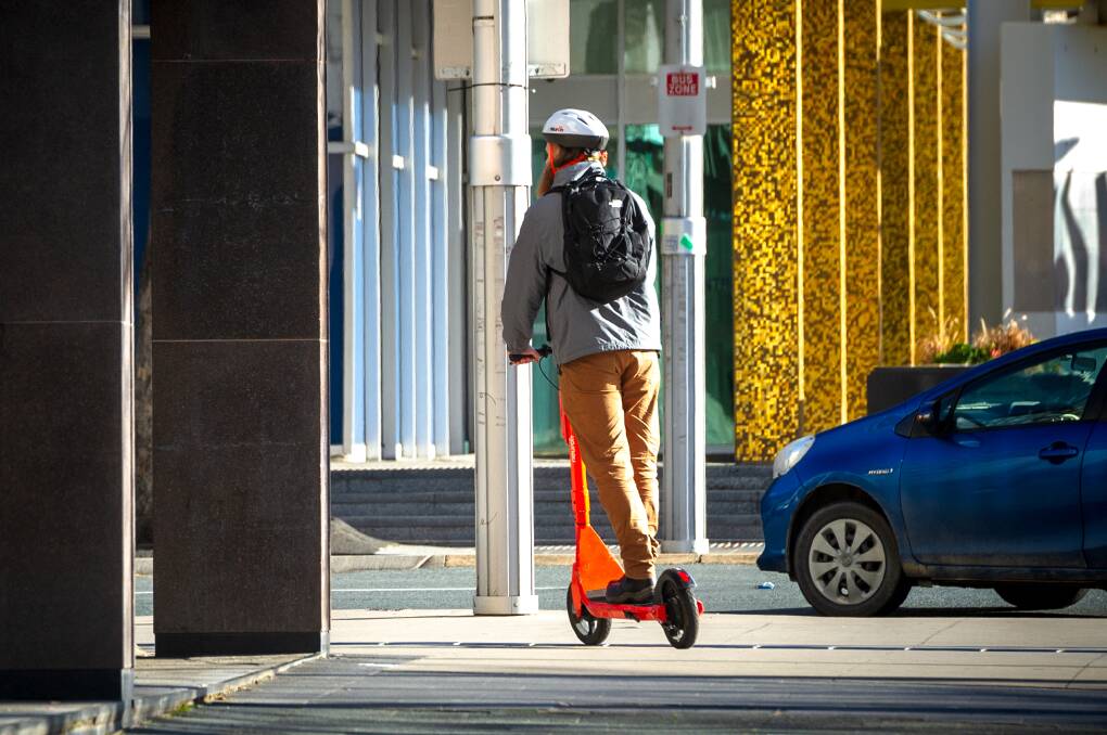 A man riding a hired e-scooter in Canberra. Picture by Canberra Times