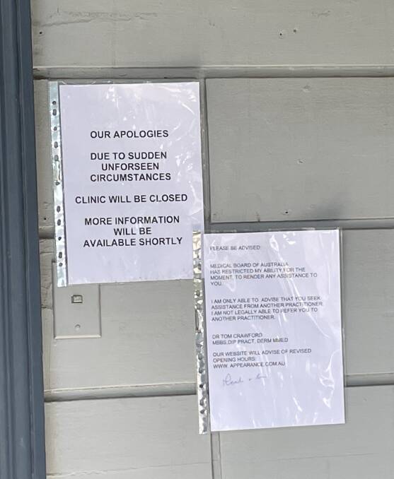 Two notices next to the clinic's front door notify the public of the clinic's closure and the Medical Board of Australia "restricting" Dr Crawford. Picture by Jonathon Magrath