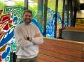 Troy Firebrace with his mural of Bendigo Creek at the Bendigo Library. Picture by Jonathon Magrath