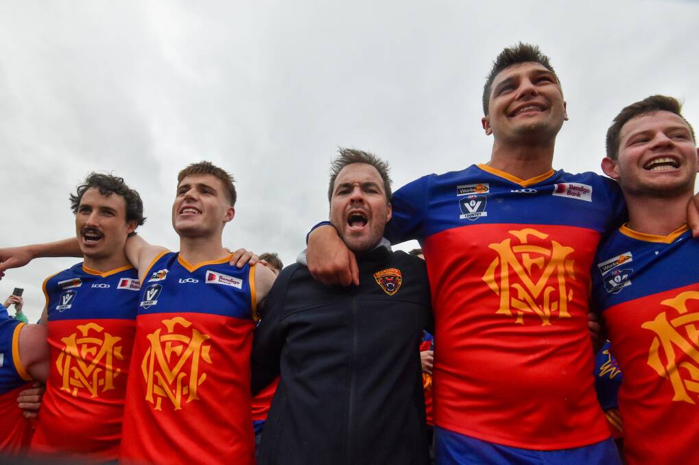 Grenfell (second from right) and coach Linton Jacobs (middle) sing the song following the Panthers 2023 grand final win. Picture by Darren Howe 