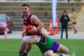Nullawil's Dean Smith tries to elude a Birchip-Watchem tackler during their preliminary final last Saturday. Picture by Blake Lee