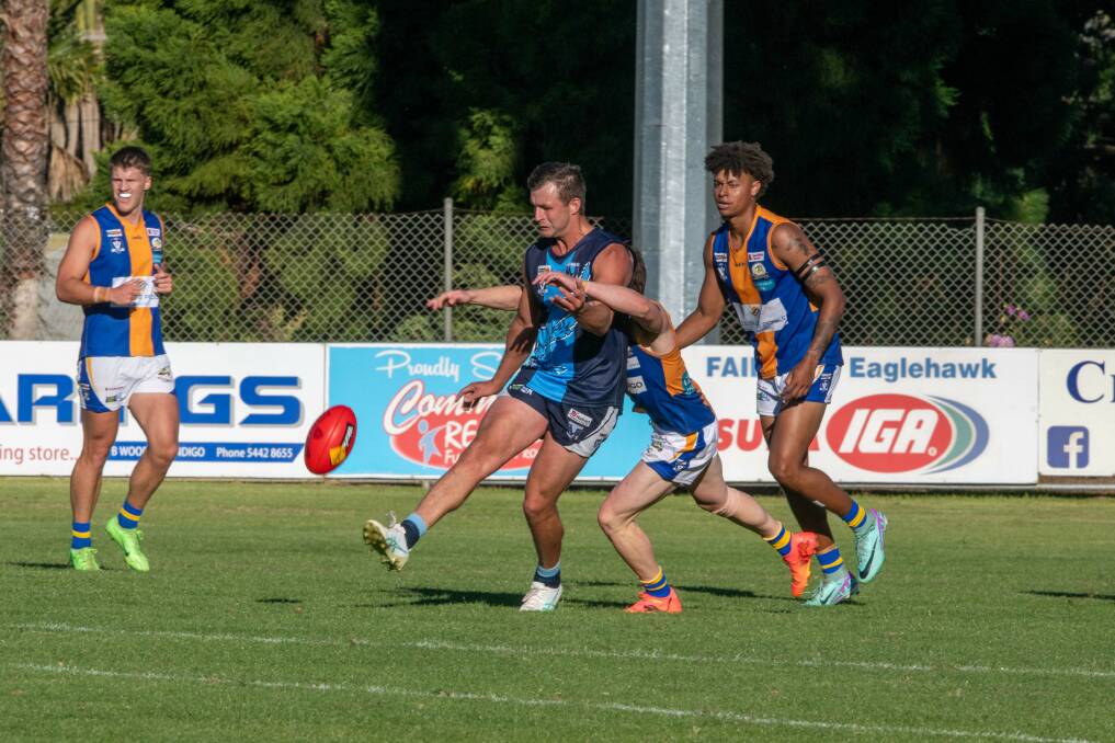 Billy Evans gets his kick away just in time. Picture by Enzo Tomasiello