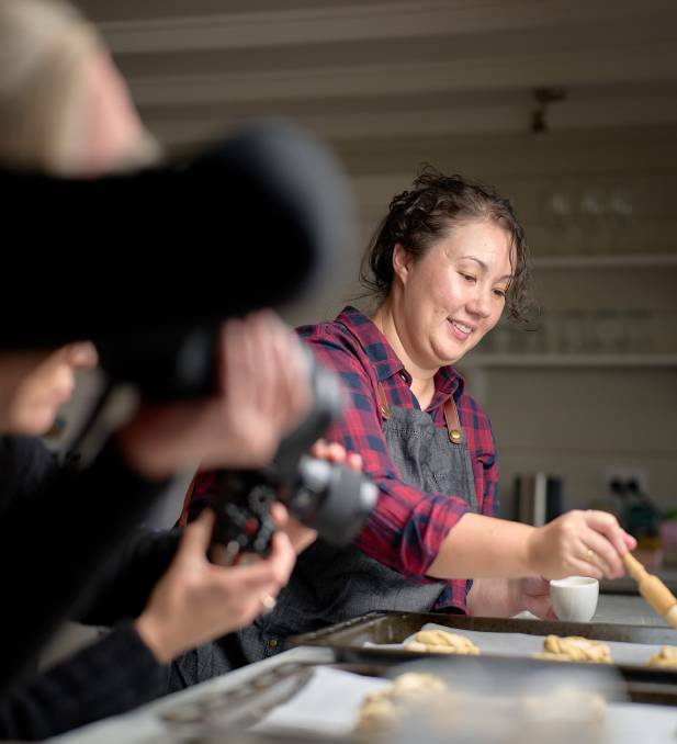 Iron Chef Shellie Froidevaux at work in her kitchen as workshop participants photograph her cooking. Picture supplied