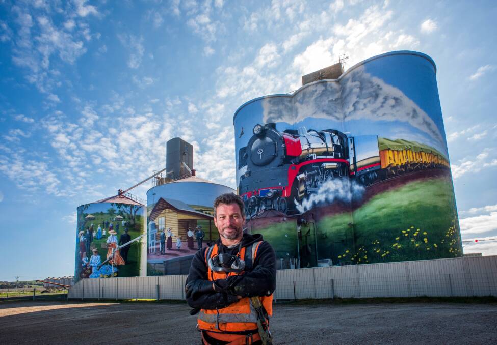 Artist Tim Bowtell with his Colbinabbin Silo Art. Picture file
