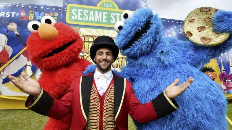 Elmo and Cookie Monster pose with the ringmaster outside the Sesame Street Circus Spectacular. Picture: supplied