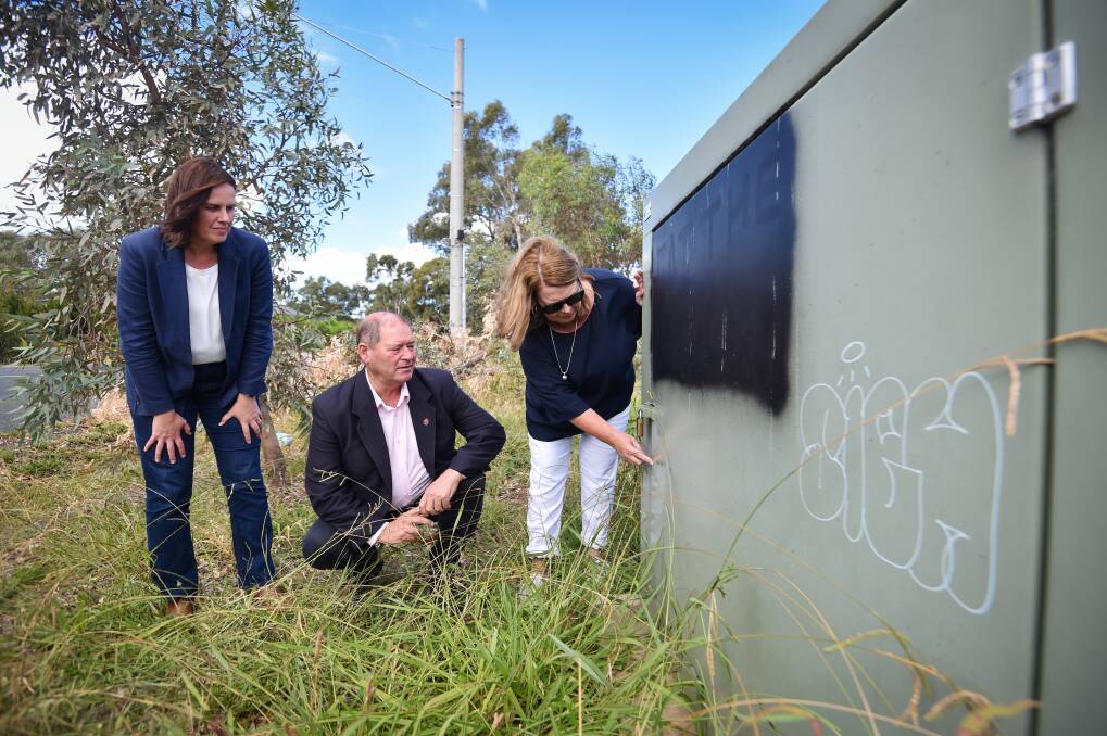 Huntly resident Trudi Marshall shows shadow water minister Tim McCurdy and Nationals MP Gael Broad where the water reached in January floods. Picture by Darren Howe