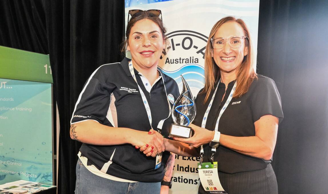 Tiffany Goncalves from Yarra Valley Water accepts the trophy for Best Tasting Tap Water from Teresa Travaglia. Picture by Enzo Tomasiello