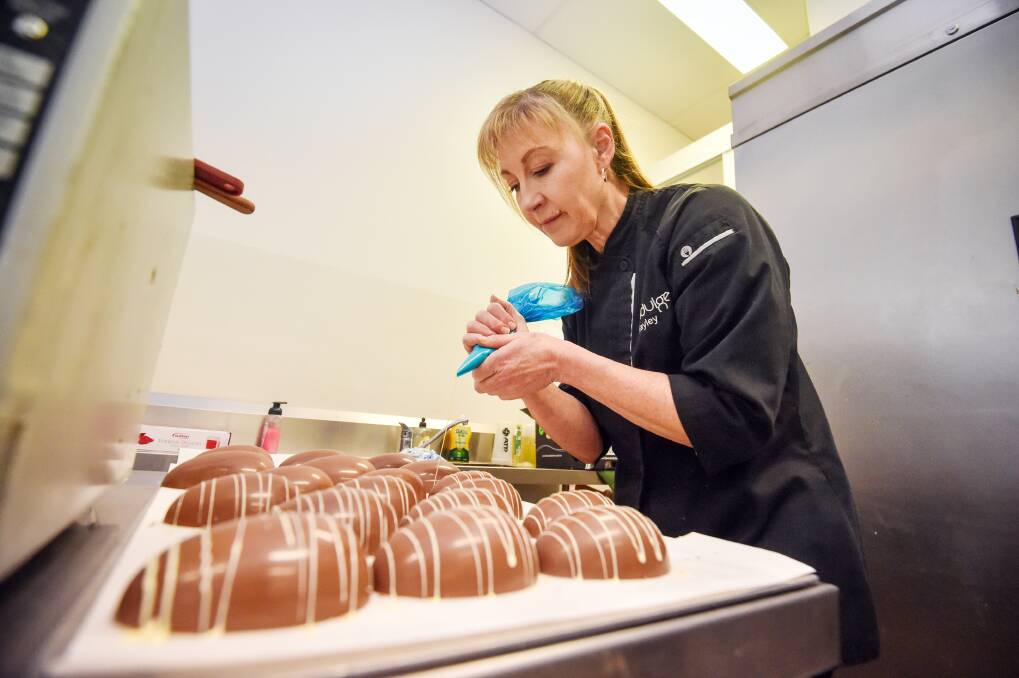 Hayley Tibbett prepares chocolate eggs for Easter. Picture by Darren Howe