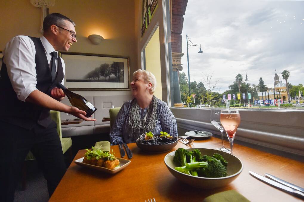 Bendigo Mayor Andrea Metcalf and Alium front of house, Nicolas Thomas, discuss French wine. Picture by Darren Howe