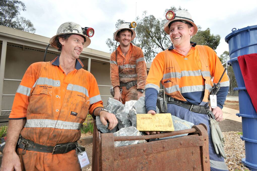 Mine workers Andrew Aitken, Nathan Coyle and Curtis Doherty celebrate pouring Fosterville's one millionth ounce of gold last year. Picture: NONI HYETT
