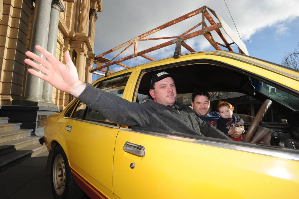 Ben Hall and Andrew Quin with Andrew's son Jayvon in Ben's 1981 Holden Commodore they plan to enter into the Variety Bash. Picture: NONI HYETT