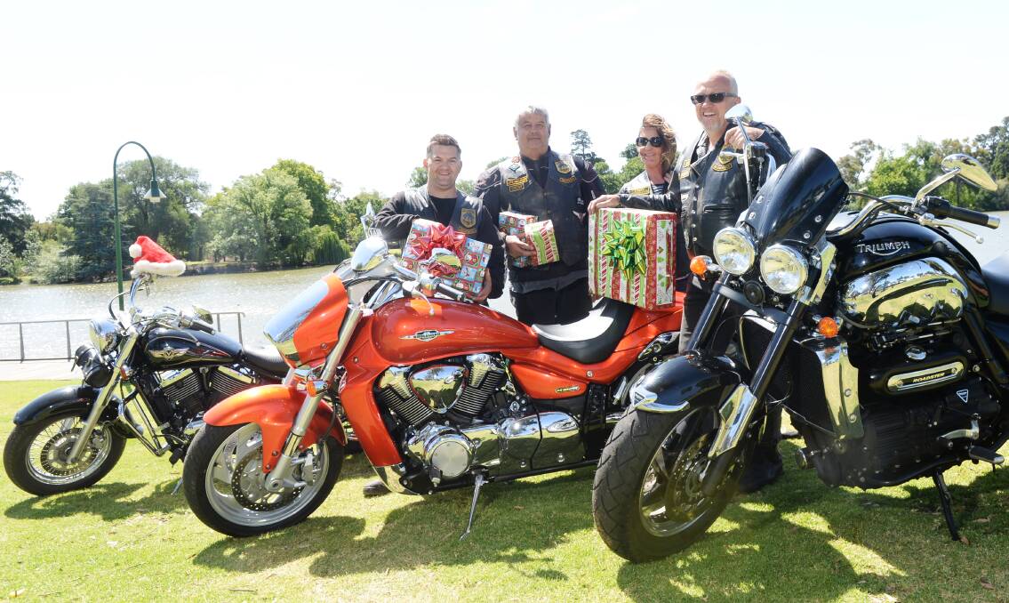 The Allies Motorcycle Club's Joel "Chook" Fitzgerald, Rob "Tank" Matheson, John "Snow" Woolley and Annie Matheson prepare for the club's annual charity toy run. Picture: DARREN HOWE