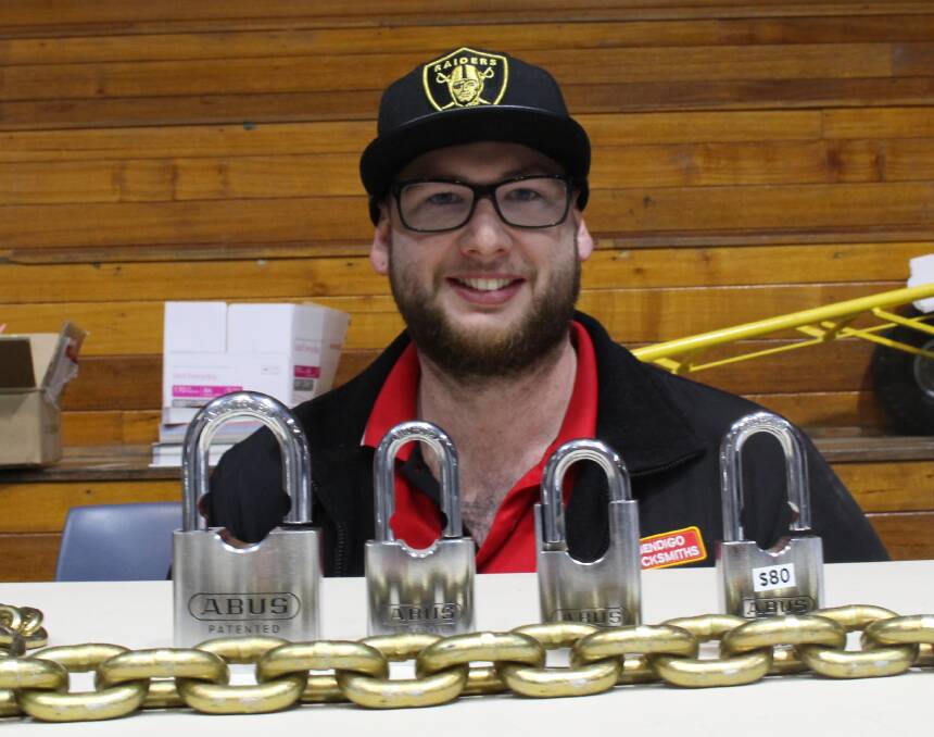 Lock it in: Bendigo Locksmiths' Kyle Bevans shows off his wares at the Farm Security Expo. Picture: JASON WALLS