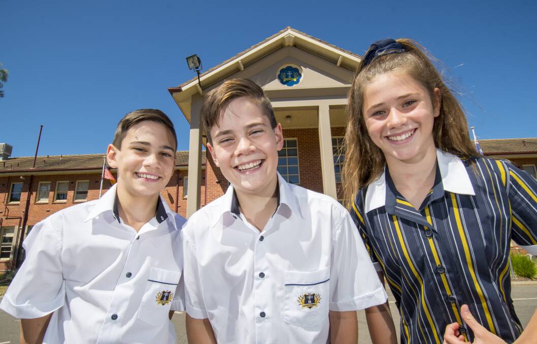 Twins Joseph and Daniel Artavilla and new classmate Demi Skinner, all 12, are excited for day one at Catherine McAuley College on Friday. The school will have an extra year seven class this year after an increase in enrolments. Picture: DARREN HOWE