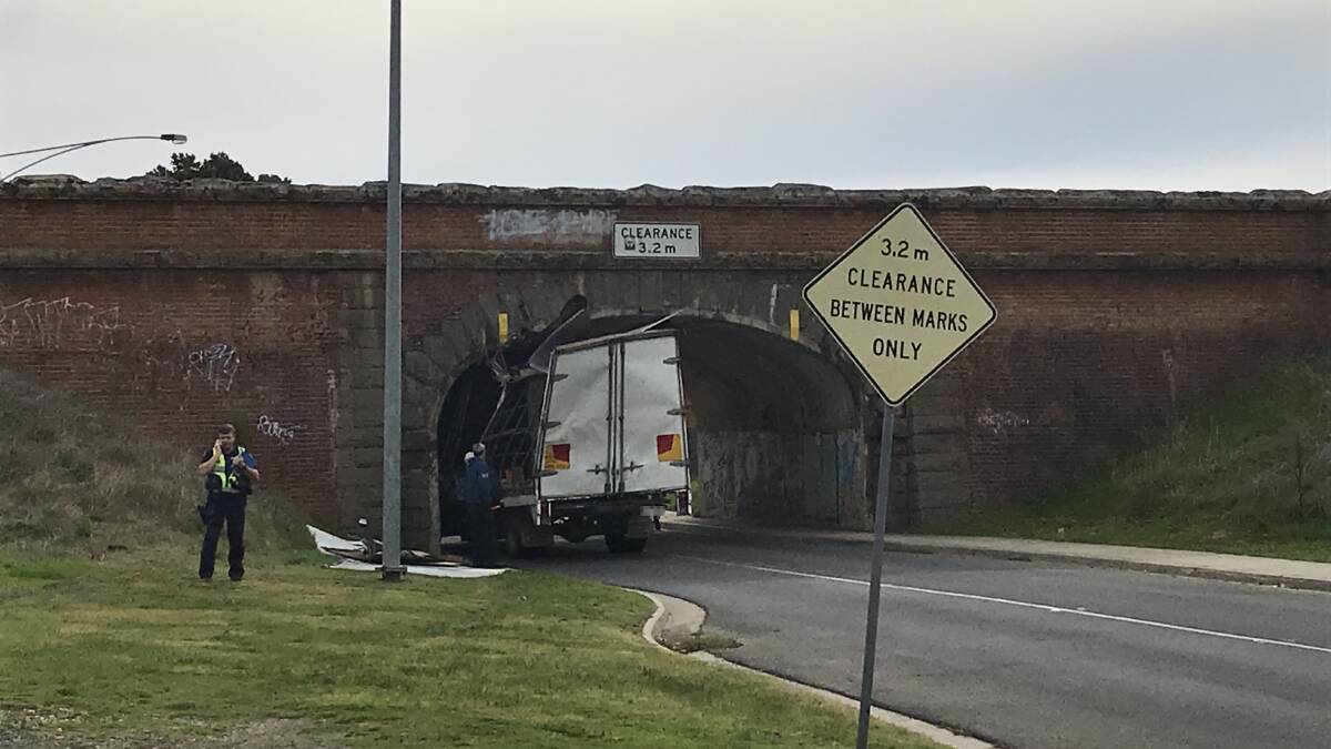 A truck gets stuck under the Laurel Street bridge... again