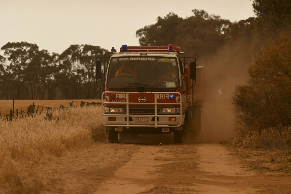 Fire fighters mop up at Hunter, near Elmore, on Thursday afternoon. Picture: NONI HYETT