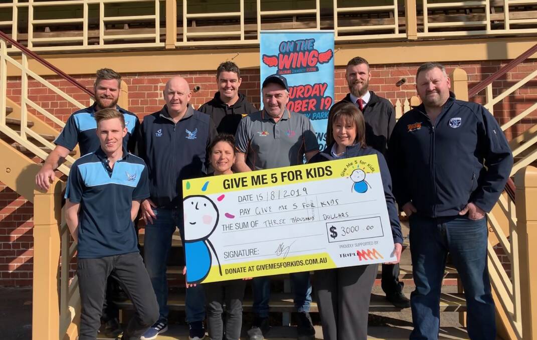 On The Wing Festival organising committee, along with sponsor representatives Ashley Piercy from Empowering Eaglehawk and Joel King from Fairleys Supa IGA, presenting a $3000 cheque for Give Me 5 For Kids. Picture: CONTRIBUTED