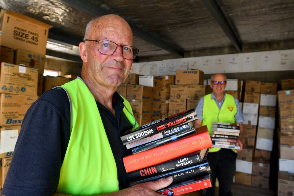 The Y Service Club's Peter Searle and Colin Lambie prepare for the first Easter book fair in two years. Picture: NONI HYETT