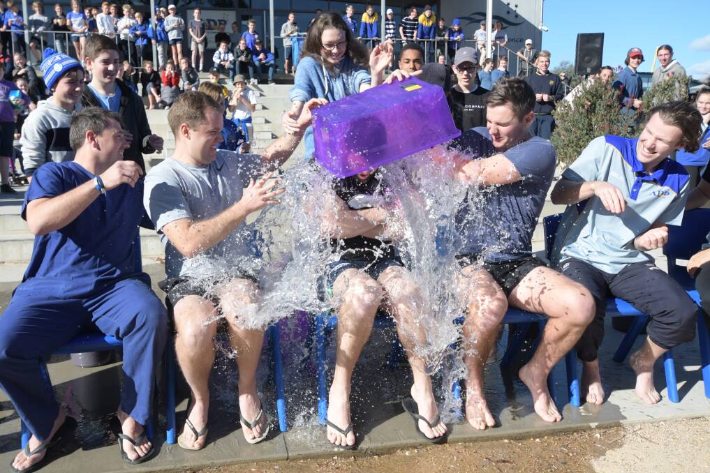Teachers from Bendigo South East take the ice bucket challenge to fundraise for charity Fight Motor Neurone Disease, from left, Wendy Martin, David Trew, Wade McMillan, Hamish Roberts, Tom Kuhune, Hugh Schaeche and Emily Gloury. Picture: NONI HYETT