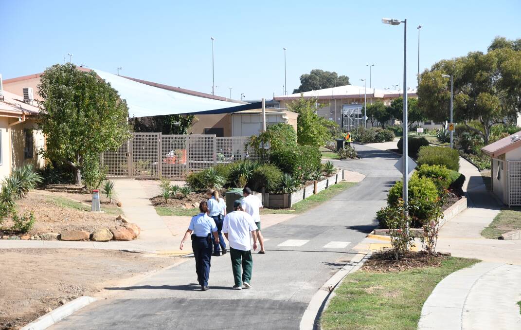 Prisoners and guards make their way across the yard at Loddon Prison. A $9.2 million medical unit - known as the Yaluk Centre - was recently opened to provide rehabilitation and other services. Picture: ADAM HOLMES