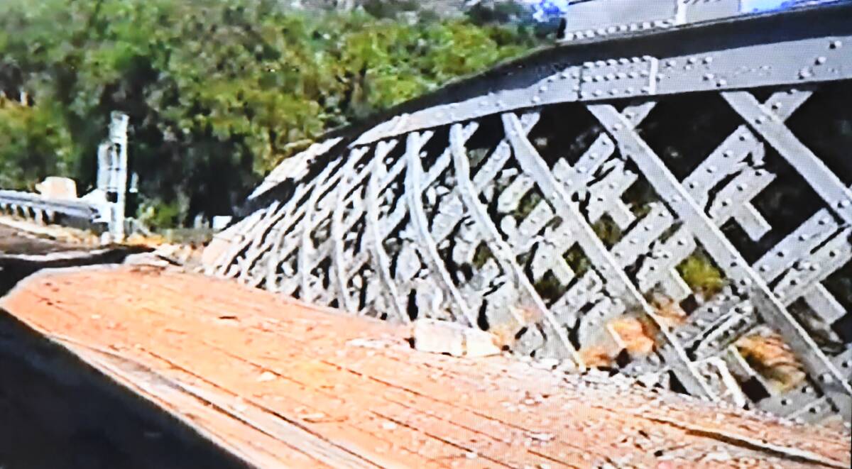Damage to the bridge in 1999 after a truck carrying a Traxcavator lost its brakes and careened into the side.